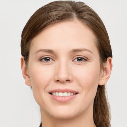 Joyful white young-adult female with long  brown hair and grey eyes