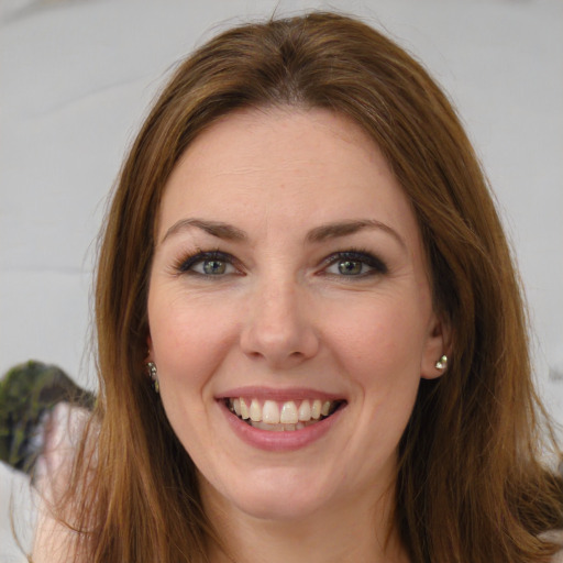 Joyful white young-adult female with long  brown hair and green eyes