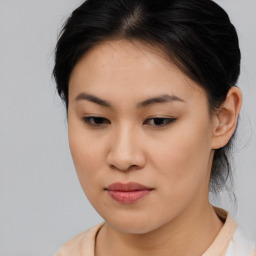 Joyful asian young-adult female with medium  brown hair and brown eyes