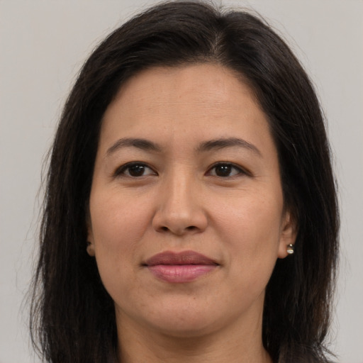 Joyful white adult female with long  brown hair and brown eyes