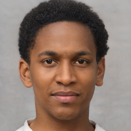 Joyful black young-adult male with short  brown hair and brown eyes