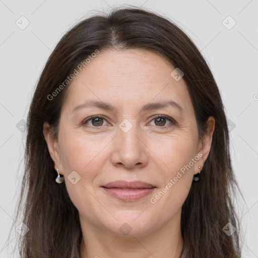 Joyful white adult female with long  brown hair and grey eyes