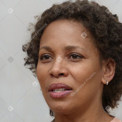 Joyful black adult female with medium  brown hair and brown eyes