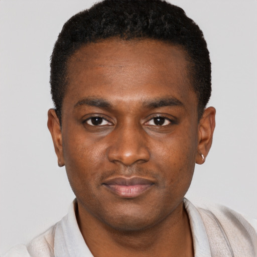 Joyful black young-adult male with short  brown hair and brown eyes