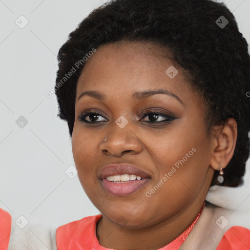 Joyful black young-adult female with short  black hair and brown eyes