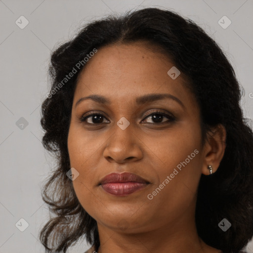 Joyful black adult female with medium  brown hair and brown eyes