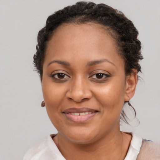 Joyful black young-adult female with short  brown hair and brown eyes