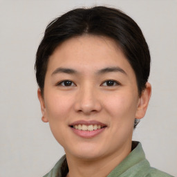 Joyful asian young-adult female with short  brown hair and brown eyes