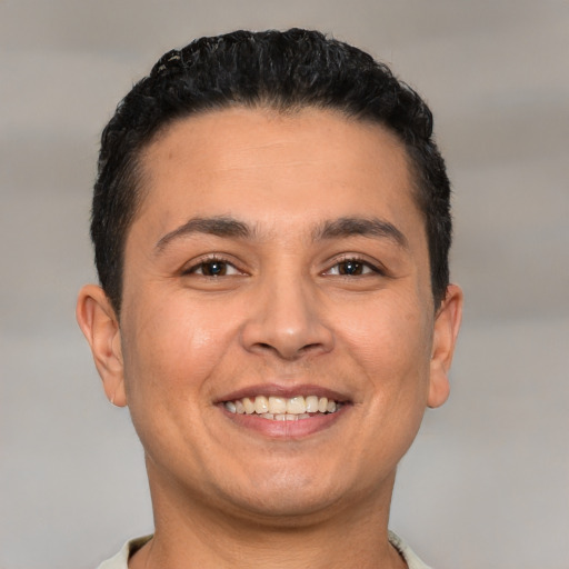 Joyful white young-adult male with short  black hair and brown eyes