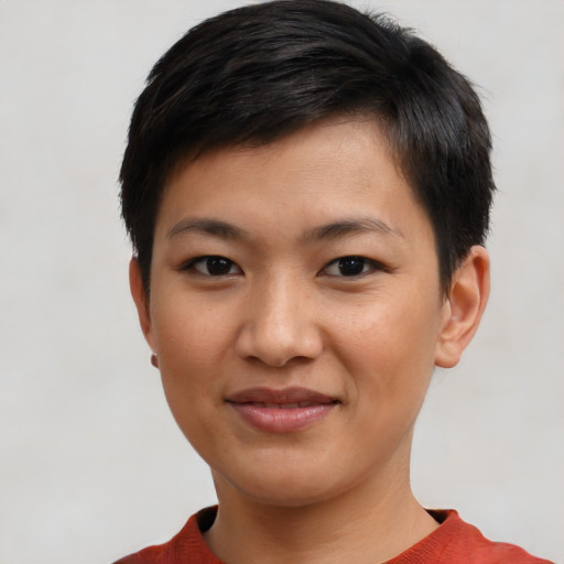 Joyful asian young-adult female with short  black hair and brown eyes