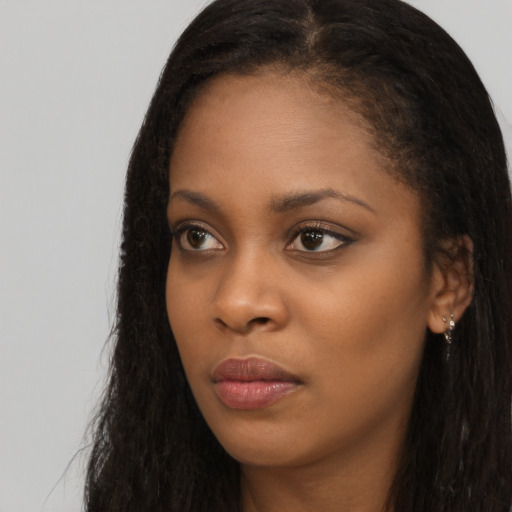 Neutral black young-adult female with long  brown hair and brown eyes