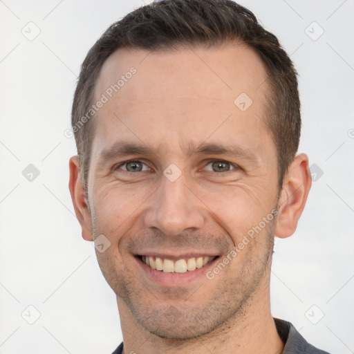 Joyful white adult male with short  brown hair and brown eyes