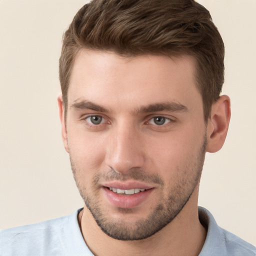 Joyful white young-adult male with short  brown hair and grey eyes