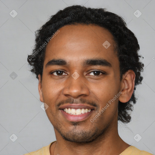 Joyful black young-adult male with short  black hair and brown eyes