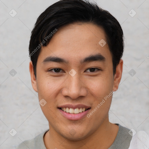 Joyful asian young-adult male with short  black hair and brown eyes