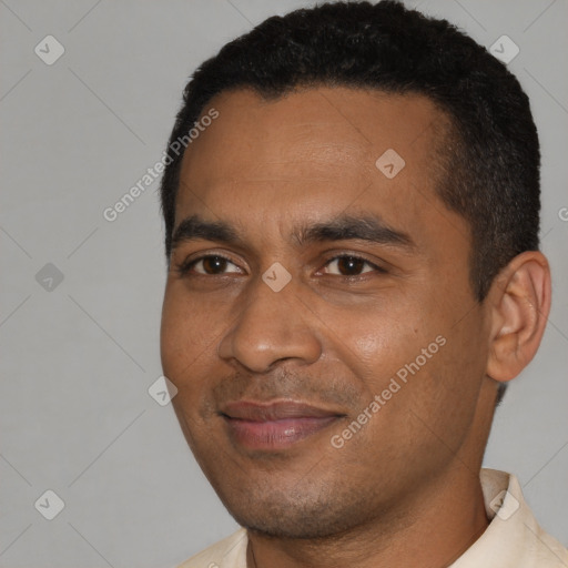 Joyful black young-adult male with short  black hair and brown eyes