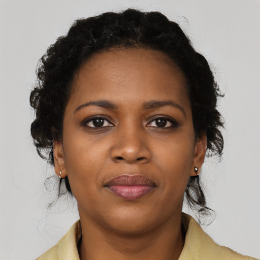 Joyful black young-adult female with medium  black hair and brown eyes