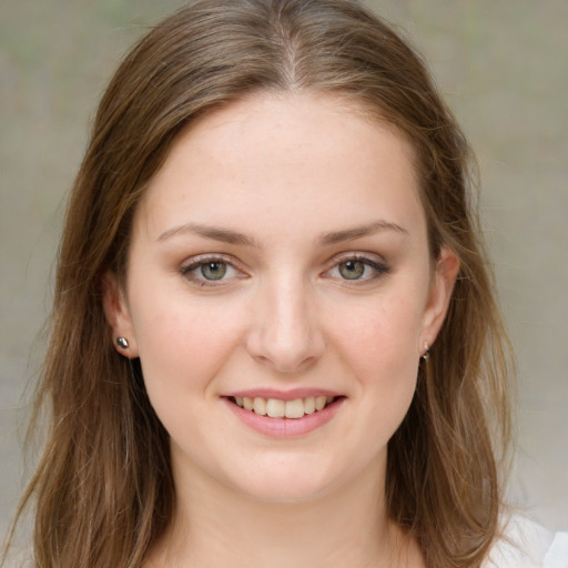 Joyful white young-adult female with medium  brown hair and green eyes