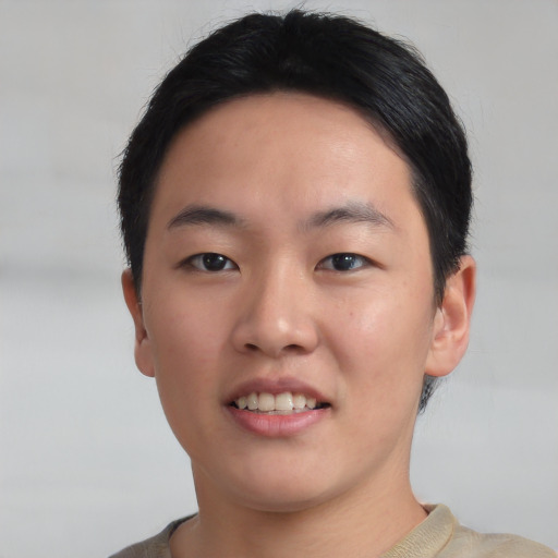 Joyful asian young-adult male with short  black hair and brown eyes