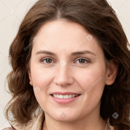 Joyful white young-adult female with long  brown hair and green eyes