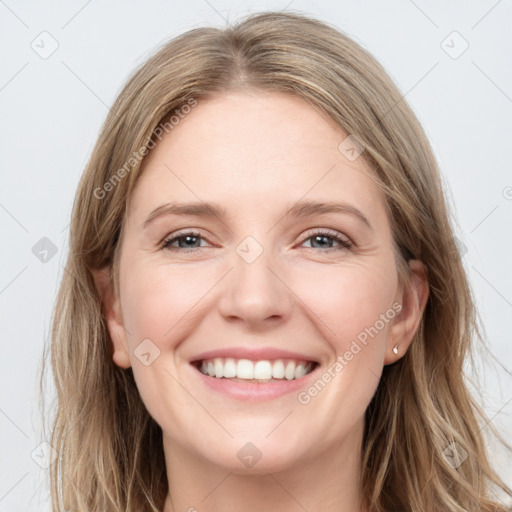 Joyful white young-adult female with long  brown hair and grey eyes