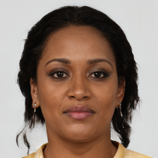 Joyful black adult female with medium  brown hair and brown eyes