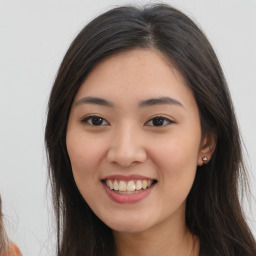 Joyful asian young-adult female with long  brown hair and brown eyes