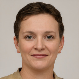 Joyful white young-adult female with short  brown hair and grey eyes