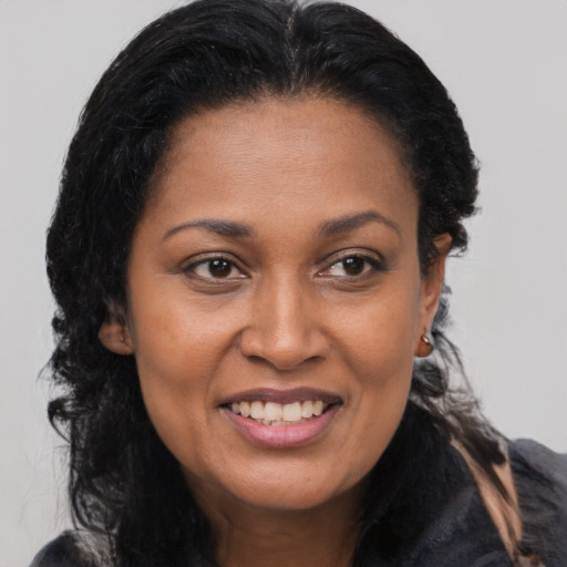 Joyful latino young-adult female with long  brown hair and brown eyes