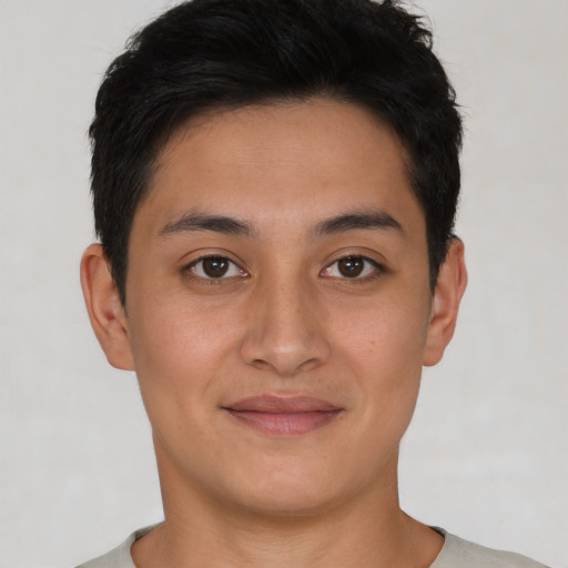 Joyful latino young-adult male with short  brown hair and brown eyes