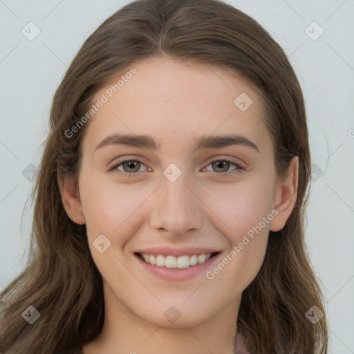 Joyful white young-adult female with long  brown hair and green eyes