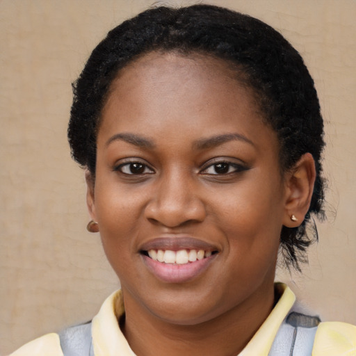 Joyful black young-adult female with short  black hair and brown eyes