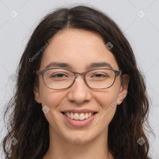 Joyful white adult female with long  brown hair and brown eyes