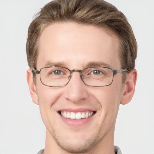 Joyful white adult male with short  brown hair and grey eyes