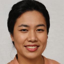 Joyful asian young-adult female with short  black hair and brown eyes