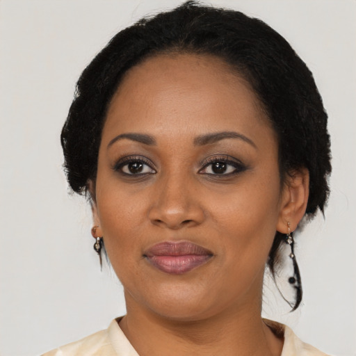 Joyful black adult female with medium  black hair and brown eyes