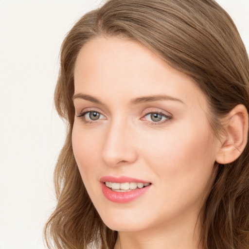 Joyful white young-adult female with long  brown hair and blue eyes