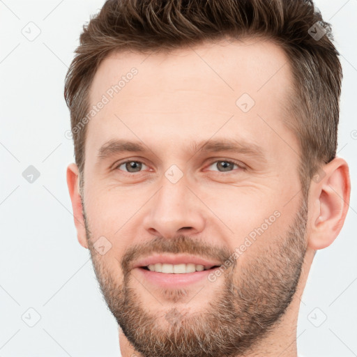 Joyful white young-adult male with short  brown hair and brown eyes