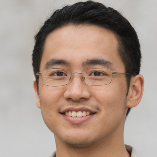 Joyful asian young-adult male with short  black hair and brown eyes