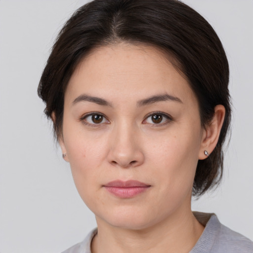 Joyful white young-adult female with medium  brown hair and brown eyes