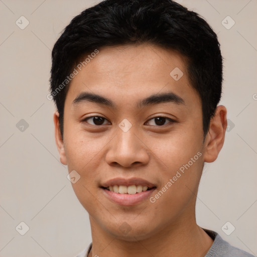 Joyful asian young-adult male with short  black hair and brown eyes