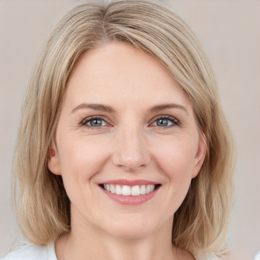 Joyful white young-adult female with medium  brown hair and blue eyes