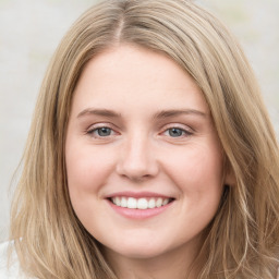 Joyful white young-adult female with long  brown hair and green eyes