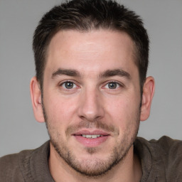 Joyful white young-adult male with short  brown hair and brown eyes