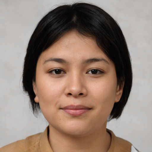 Joyful asian young-adult female with medium  brown hair and brown eyes