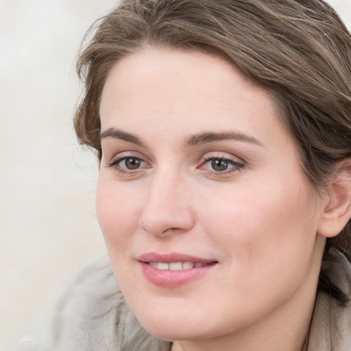 Joyful white young-adult female with long  brown hair and blue eyes