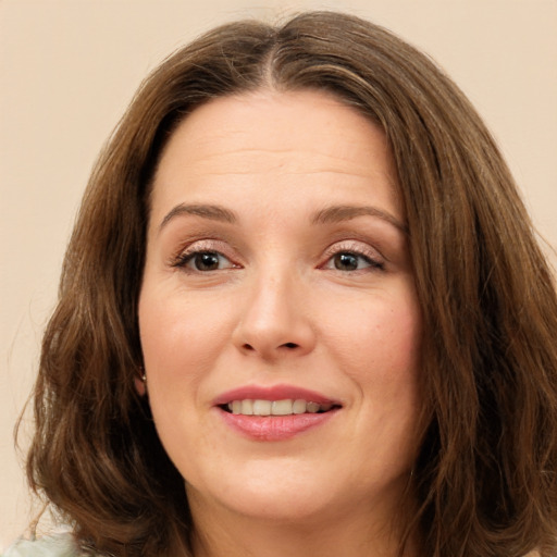 Joyful white adult female with long  brown hair and brown eyes