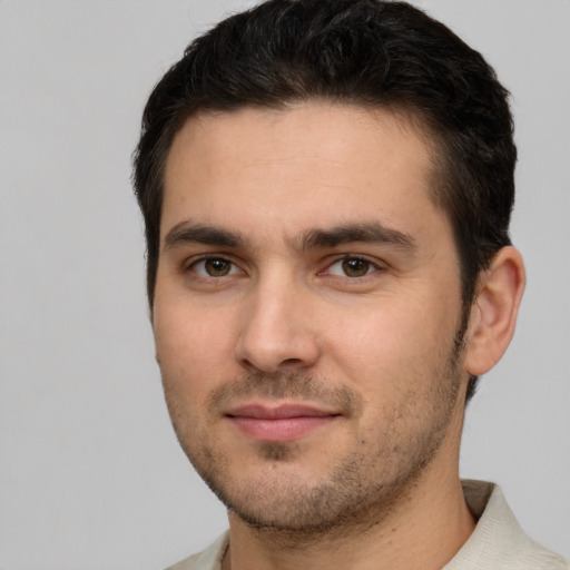 Joyful white young-adult male with short  brown hair and brown eyes