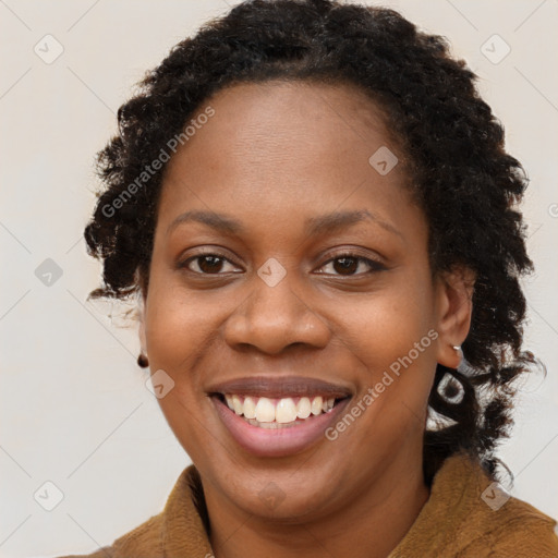 Joyful black young-adult female with long  brown hair and brown eyes