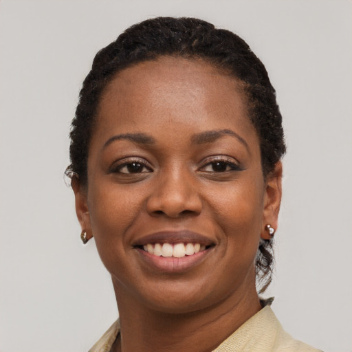 Joyful black young-adult female with short  black hair and brown eyes